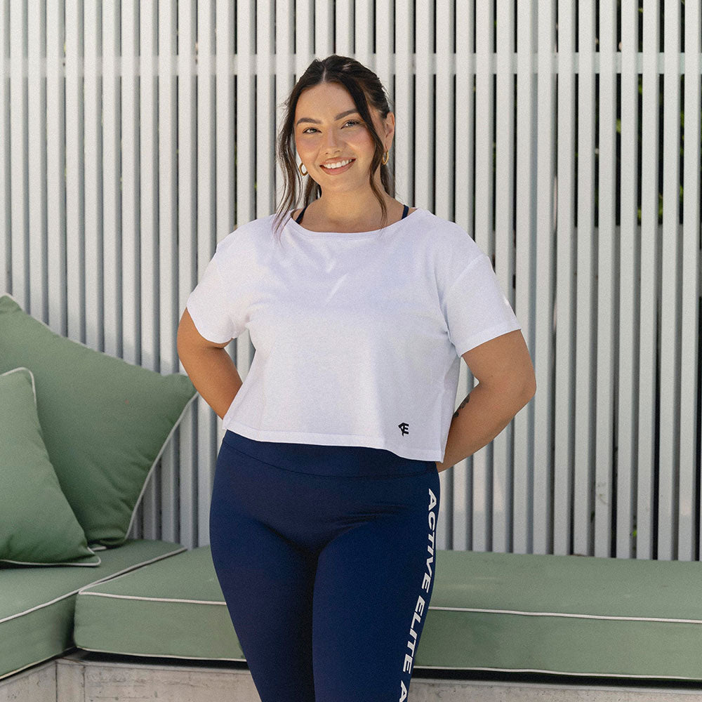 A front view of a woman wearing a cropped fitness top, displaying a relaxed and stylish fit perfect for workouts.