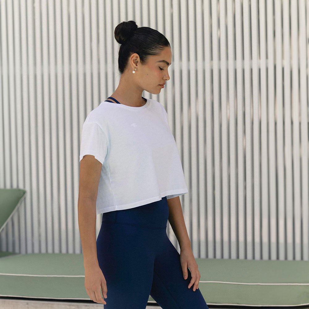 A side profile of a woman in a cropped fitness top, highlighting the sleek and comfortable design.